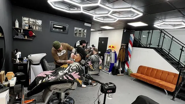 Inside: barbers at work under hexagon lights